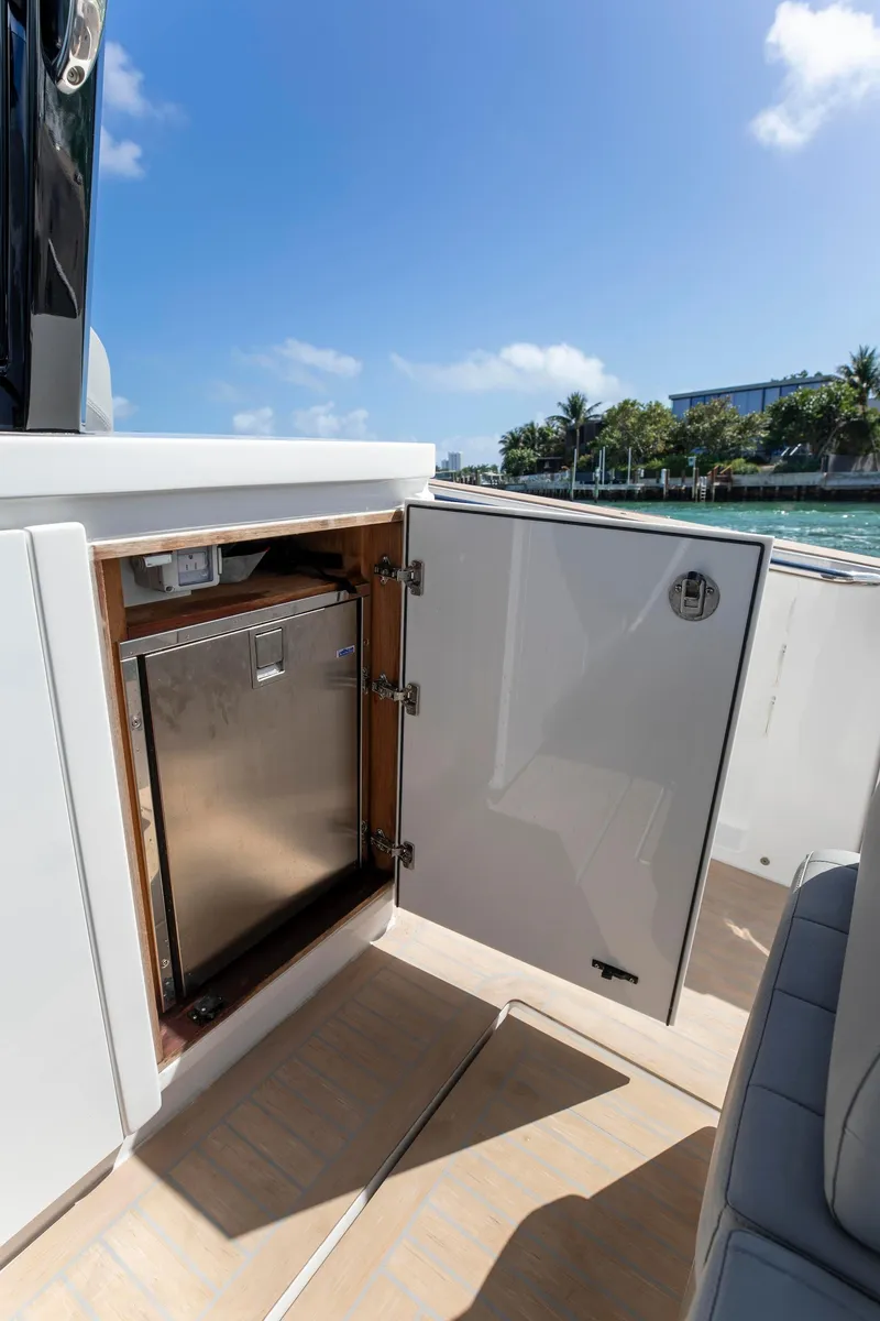 Slide: The Image of 2022 Pardo Yachts 38, open cabinet with stainless steel interior, sunny day by the water. - 50