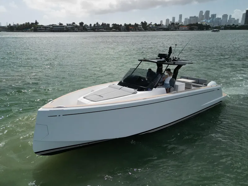 Slide: The Image of 2022 Pardo Yachts 38 cruising in clear waters near a city skyline. - 28