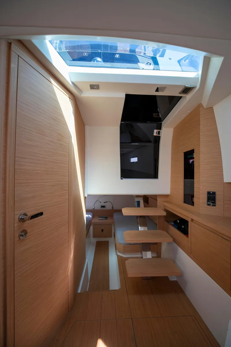 Slide: The Image of Interior of 2022 Pardo Yachts 38, featuring modern wood finishes and skylight. - 52
