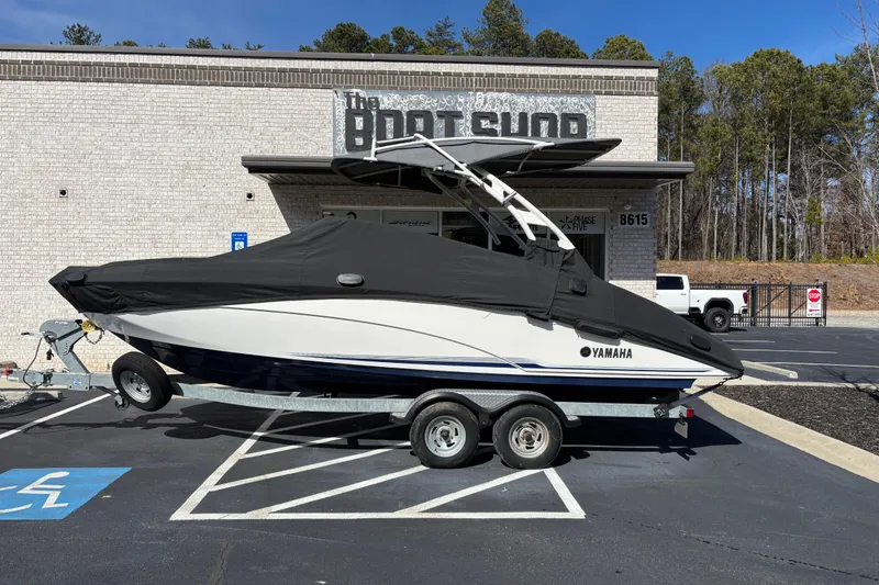 Slide: The Image of 2017 Yamaha 242 Limited SE-Series boat on trailer, parked outside a shop. - 5