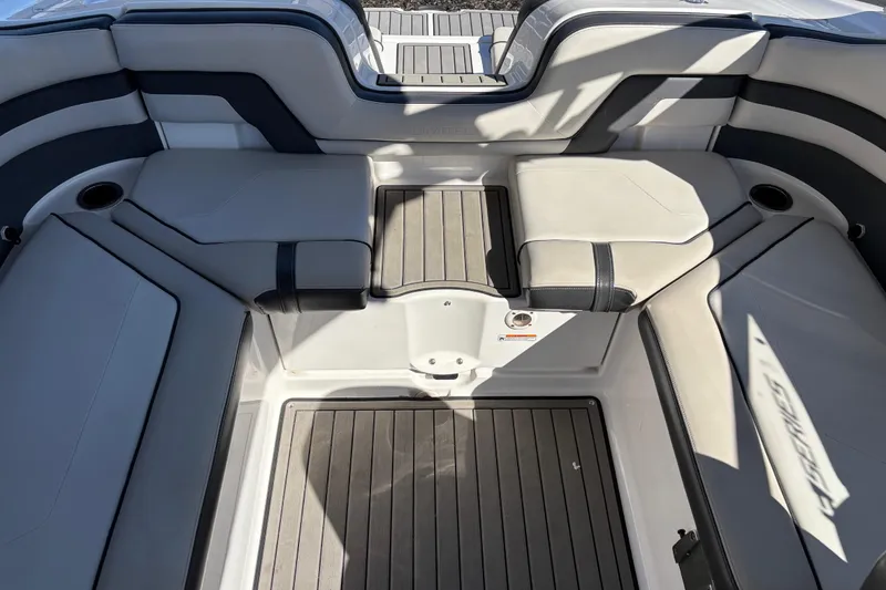 Slide: The Image of 2017 Yamaha 242 Limited SE-Series boat interior with cushioned seating and cup holders. - 9