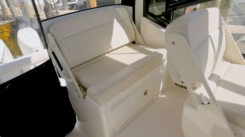Slide: The Image of Interior of 2023 Boston Whaler 325 Conquest with beige seating. - 12