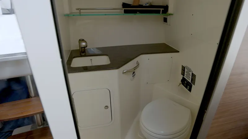 Slide: The Image of Interior of 2023 Boston Whaler 325 Conquest with sink and toilet. - 19