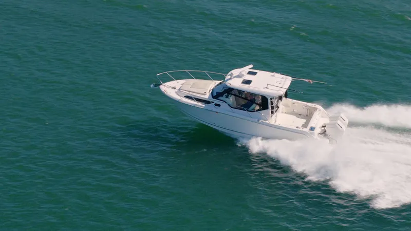 Slide: The Image of Boston Whaler 325 Conquest 2023 cruising swiftly on the water. - 2