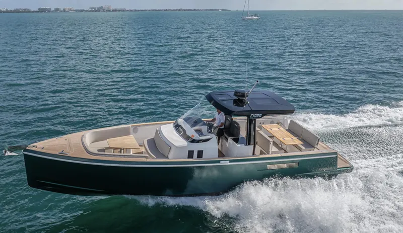 Slide: The Image of 2023 Fjord 38 motor yacht cruising on open water. - 15