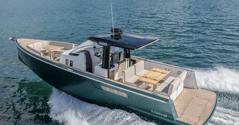 Slide: The Image of 2023 Fjord 38 motor yacht cruising on open water. - 16