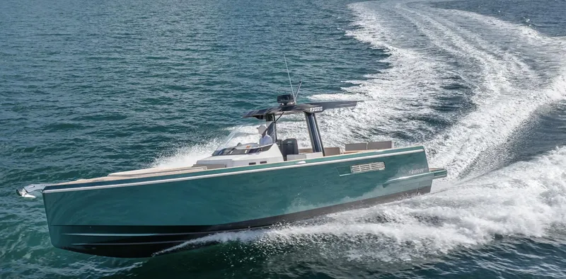 Slide: The Image of 2023 Fjord 38 motor yacht cruising on open water, creating a dynamic wake. - 20