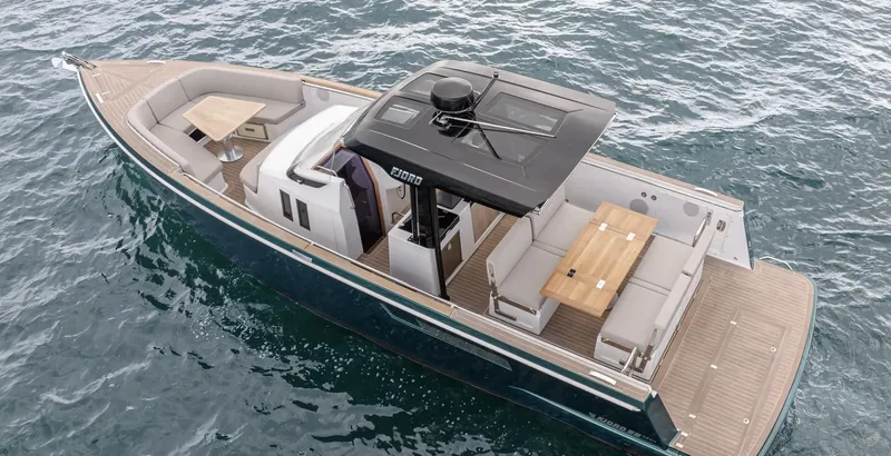 Slide: The Image of 2023 Fjord 38 boat on water, featuring spacious seating and modern design. - 21