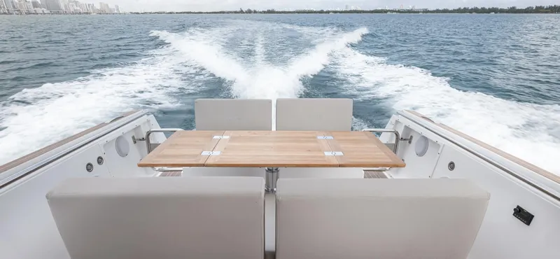 Slide: The Image of 2023 Fjord 38 yacht cruising on open water, featuring a sleek deck and seating area. - 23