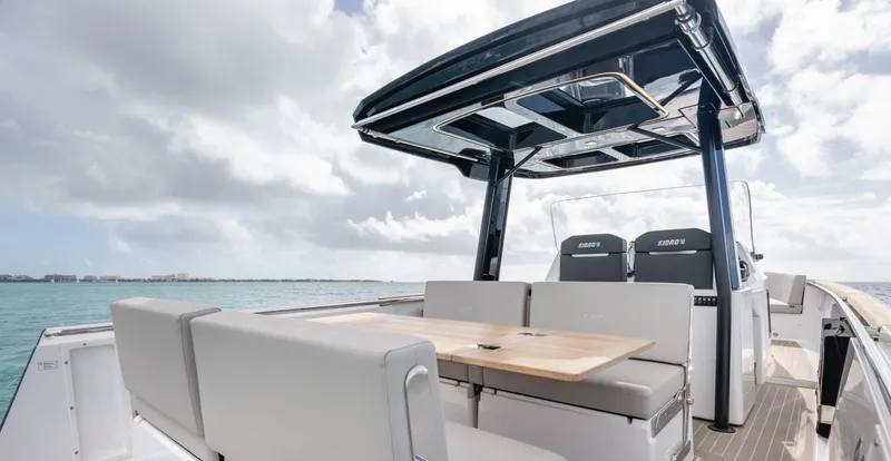 Slide: The Image of 2023 Fjord 38 yacht with sleek seating and table, cruising on open water. - 24