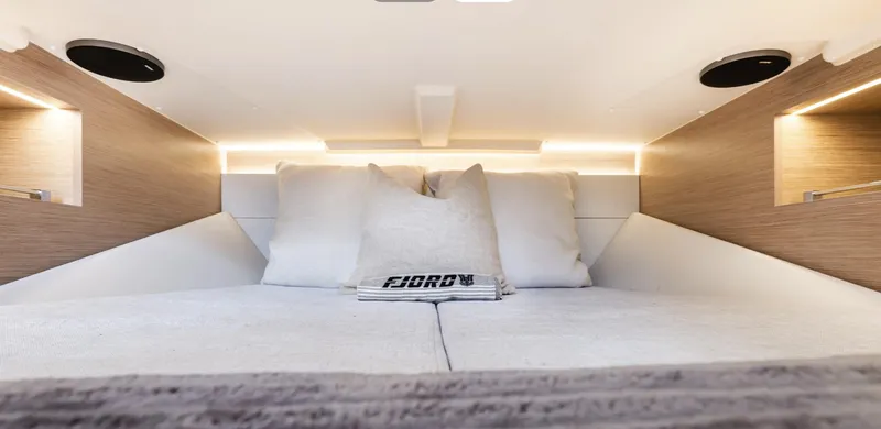 Slide: The Image of Luxurious cabin interior of 2023 Fjord 38 yacht with cozy bedding and ambient lighting. - 26