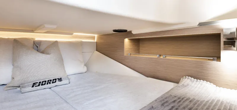 Slide: The Image of Cozy cabin interior of 2023 Fjord 38 yacht with modern bedding and ambient lighting. - 29