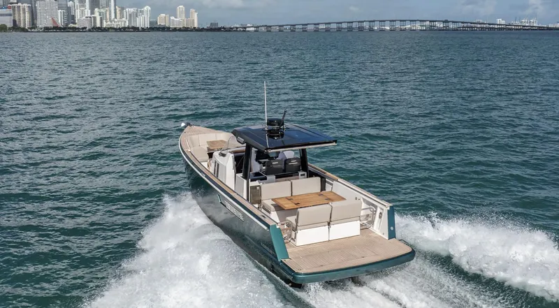 Slide: The Image of 2023 Fjord 38 boat cruising near city skyline and bridge. - 5