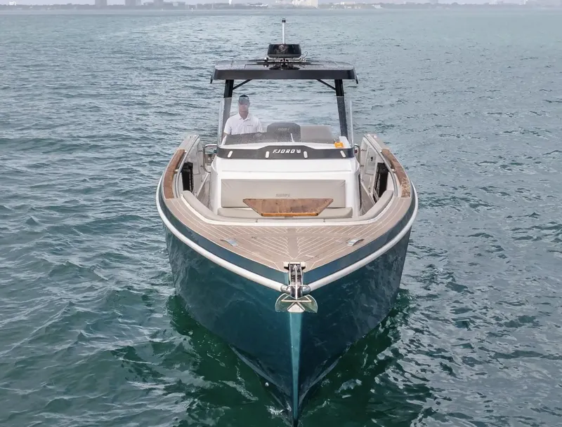 Slide: The Image of 2023 Fjord 38 boat cruising on open water, front view. - 7