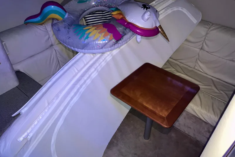 Slide: The Image of Interior of 2001 Formula 37 Performance Cruiser with inflatable unicorn float and wooden table. - 16