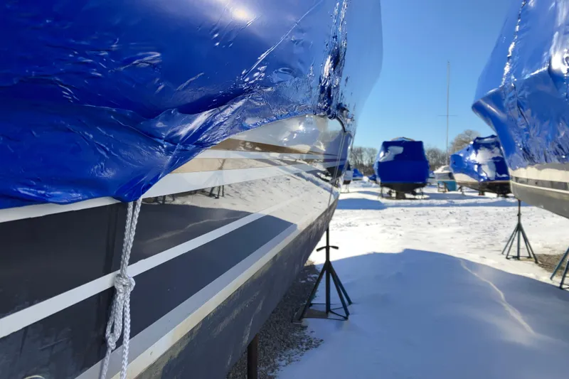 Slide: The Image of 2001 Formula 37 Performance Cruiser wrapped in blue tarp, stored outdoors in winter. - 64