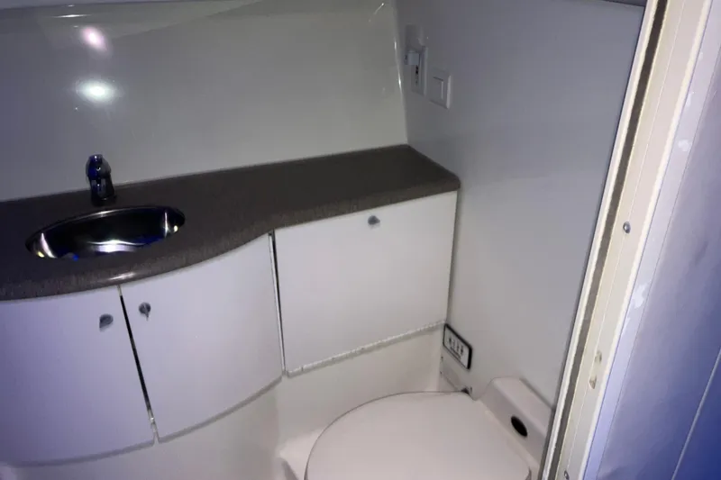 Slide: The Image of 2001 Formula 37 Performance Cruiser bathroom with sink, cabinets, and toilet. - 27