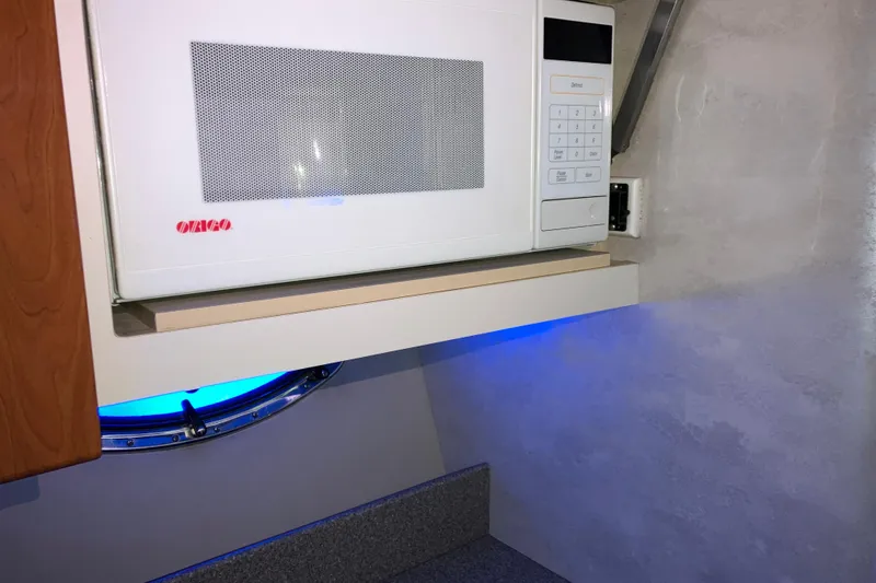 Slide: The Image of Microwave in 2001 Formula 37 Performance Cruiser kitchen with blue accent lighting. - 40