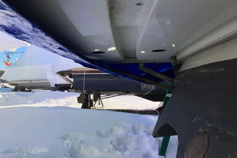 Slide: The Image of 2001 Formula 37 Performance Cruiser in snowy boatyard, hull and propeller visible. - 61