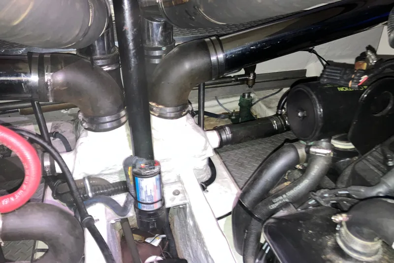 Slide: The Image of Engine compartment of a 2001 Formula 37 Performance Cruiser, showcasing pipes and mechanical components. - 43