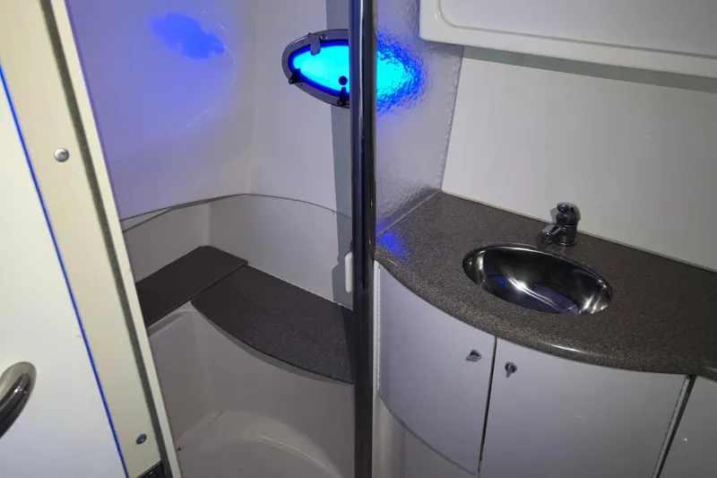 Slide: The Image of 2001 Formula 37 Performance Cruiser bathroom with sink, countertop, and blue-lit window. - 28