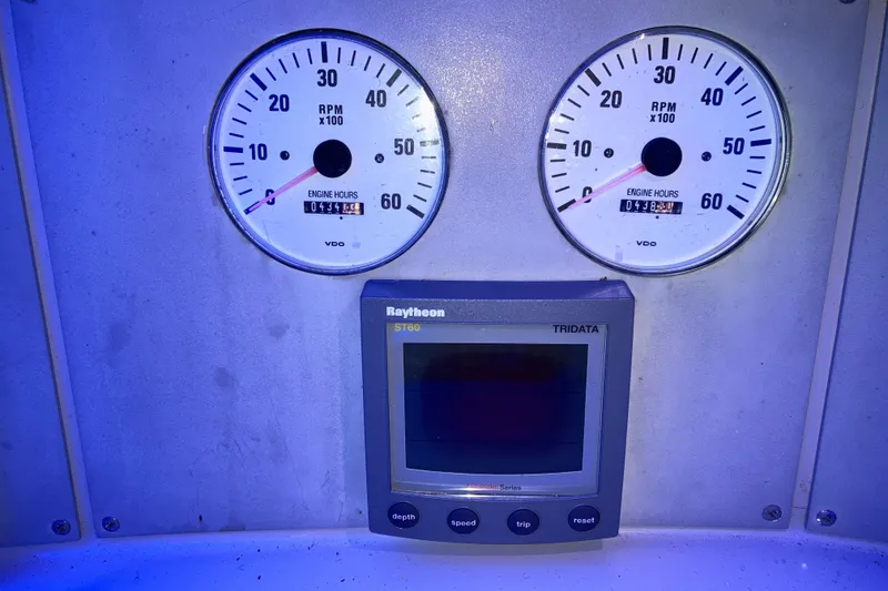 Slide: The Image of Instrument panel of a 2001 Formula 37 Performance Cruiser with RPM gauges and Raytheon ST60 display. - 14