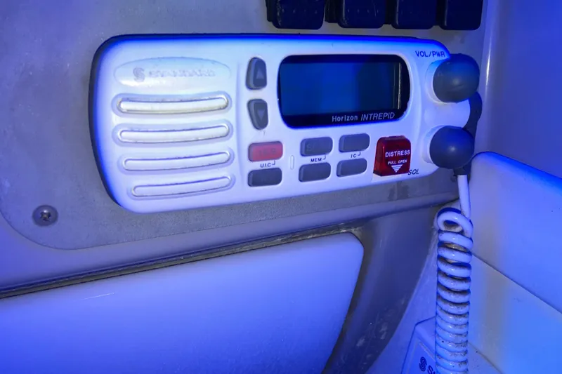 Slide: The Image of VHF radio on 2001 Formula 37 Performance Cruiser, featuring distress button and coiled microphone. - 58