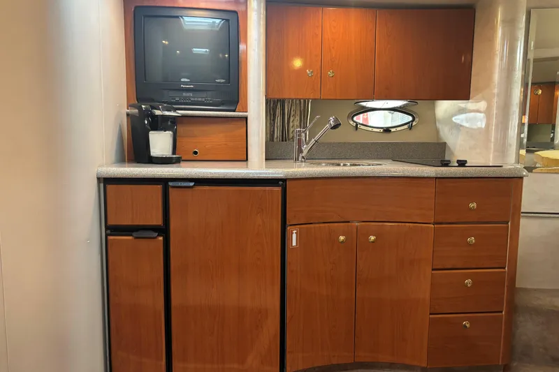 Slide: The Image of 2001 Formula 37 Performance Cruiser interior kitchen with wooden cabinets and appliances. - 6