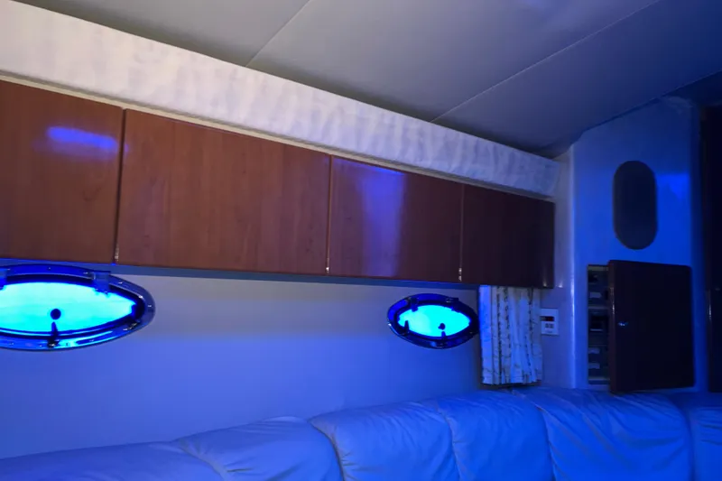 Slide: The Image of Interior of 2001 Formula 37 Performance Cruiser with blue-lit portholes and wooden cabinets. - 35