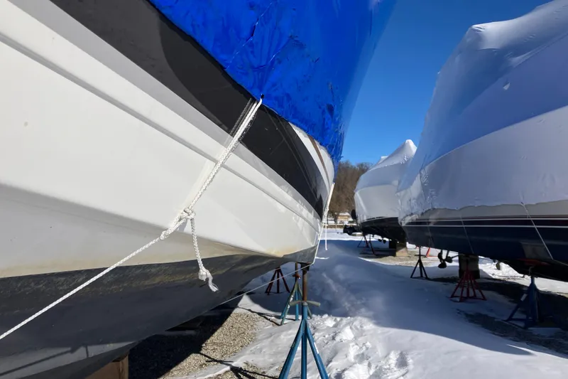 Slide: The Image of 2001 Formula 37 Performance Cruiser boats in winter storage, covered and elevated on stands. - 11