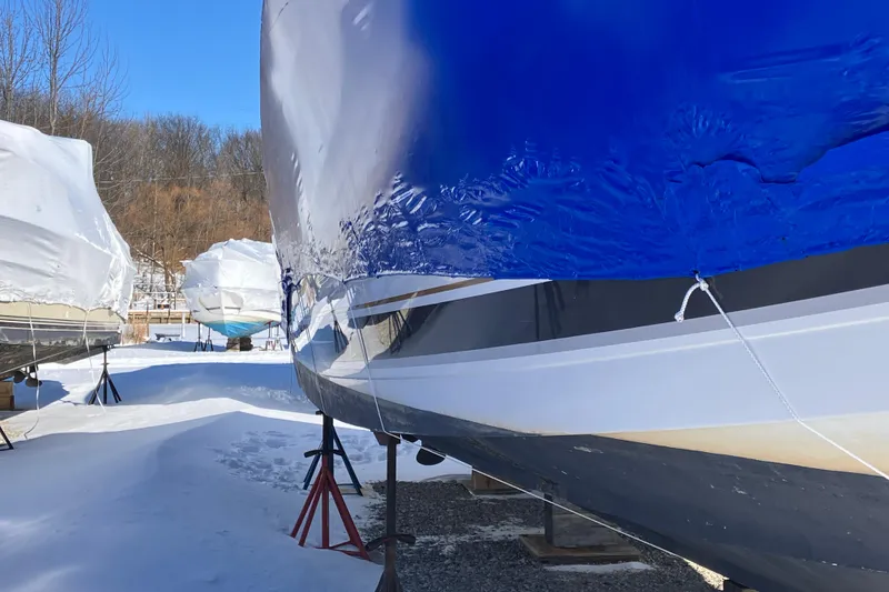 Slide: The Image of 2001 Formula 37 Performance Cruiser in winter storage, covered in blue tarp. - 13