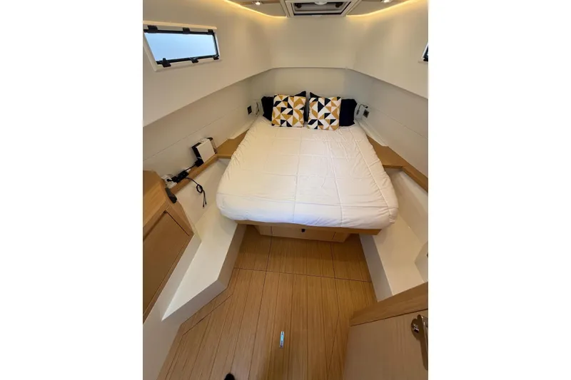 Slide: The Image of Luxurious cabin interior of 2022 Pardo Yachts 38 with modern bedding and wood accents. - 22