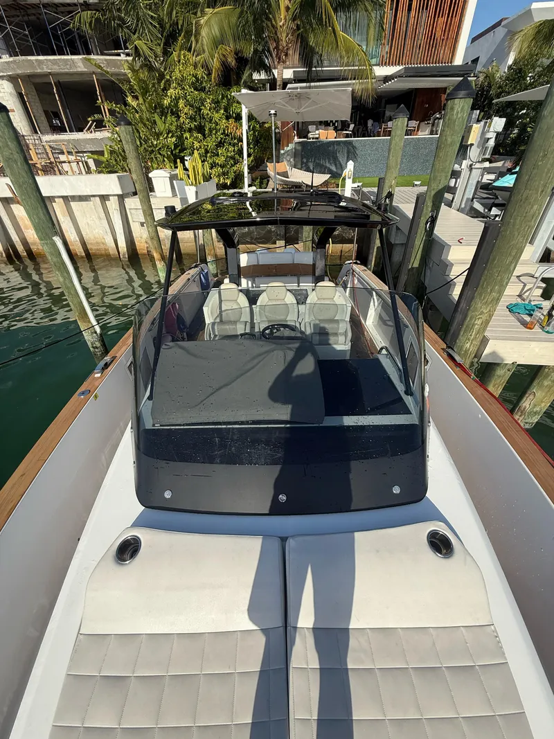 Slide: The Image of 2022 Pardo Yachts 38 docked, showcasing sleek design and luxury seating. - 11