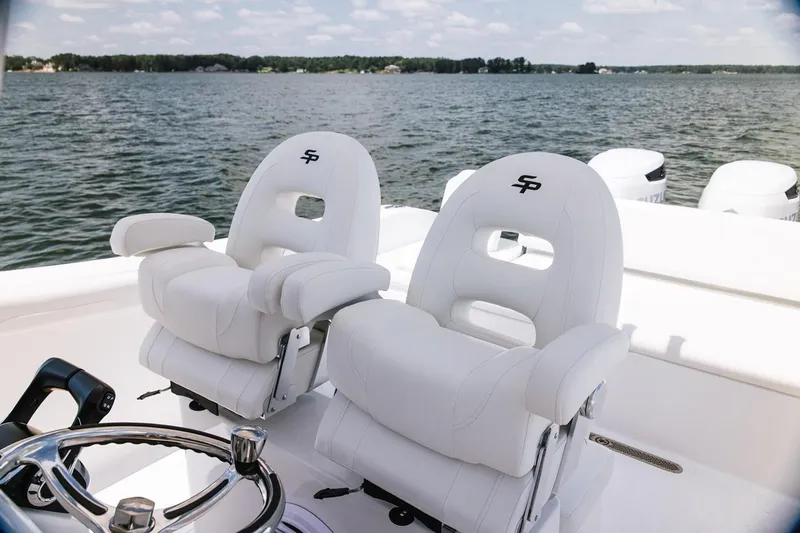 Slide: The Image of Manufacturer Provided Image: 2026 Sea Pro 265FLX Sandbar boat with luxurious white seating on a serene lake. - 5