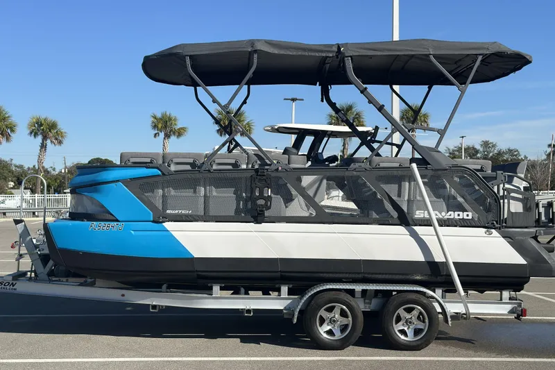 The Image of 2022 Sea-Doo Switch Sport 21 on trailer, blue and white, parked outdoors. - 0