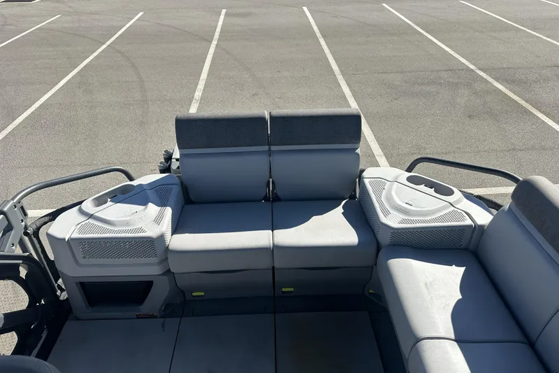 Slide: The Image of 2022 Sea-Doo Switch Sport 21 interior seating in a parking lot. - 14