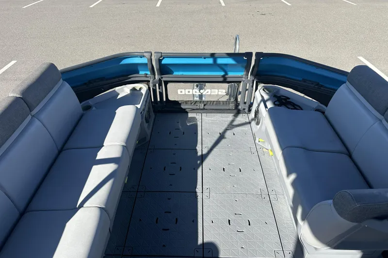 Slide: The Image of 2022 Sea-Doo Switch Sport 21 interior with gray seating and spacious deck layout. - 18