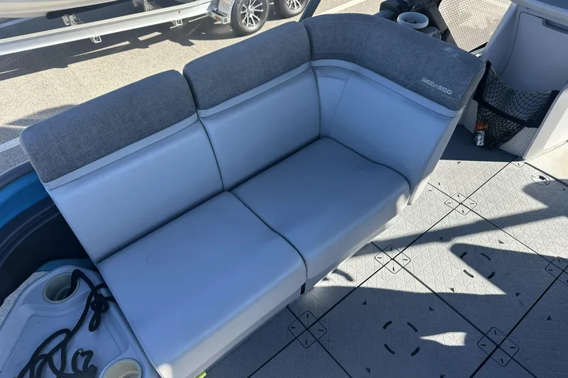 Slide: The Image of 2022 Sea-Doo Switch Sport 21 interior seating with gray upholstery and cup holders. - 20