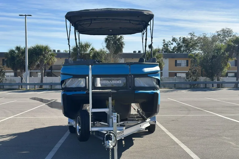 Slide: The Image of 2022 Sea-Doo Switch Sport 21 on trailer in sunny parking lot. - 6