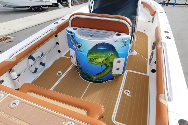 Slide: The Image of 2008 Wellcraft 27 Scarab Tournament boat interior with fish-themed design and tan seating. - 11