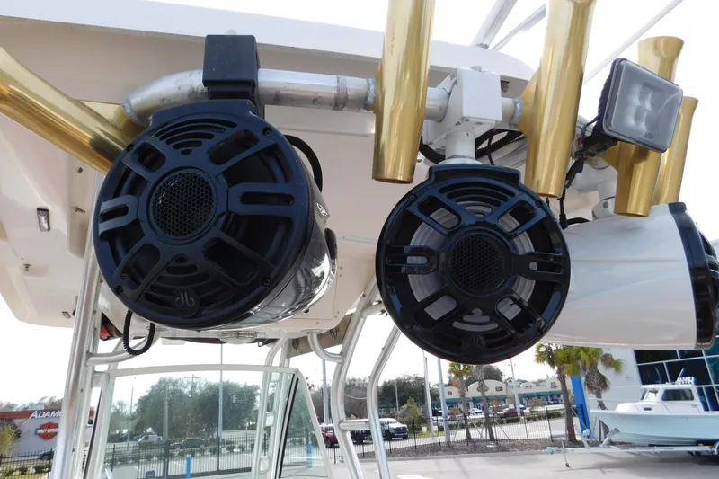 Slide: The Image of 2008 Wellcraft 27 Scarab Tournament boat speakers and rod holders, docked outdoors. - 25