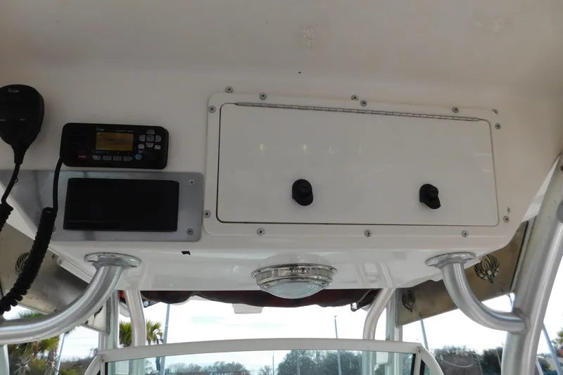 Slide: The Image of 2008 Wellcraft 27 Scarab Tournament boat console with radio and storage compartment. - 32