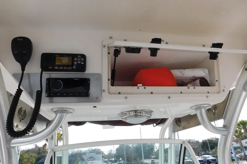 Slide: The Image of 2008 Wellcraft 27 Scarab Tournament boat console with radio and storage compartment. - 33