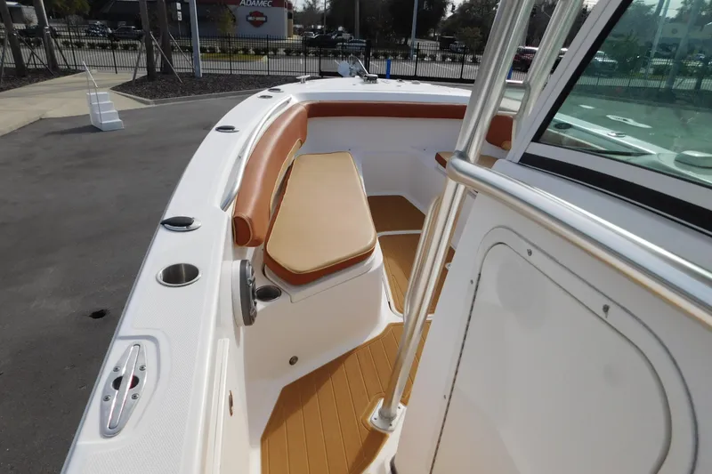 Slide: The Image of 2008 Wellcraft 27 Scarab Tournament boat interior with tan seating and cup holders. - 39