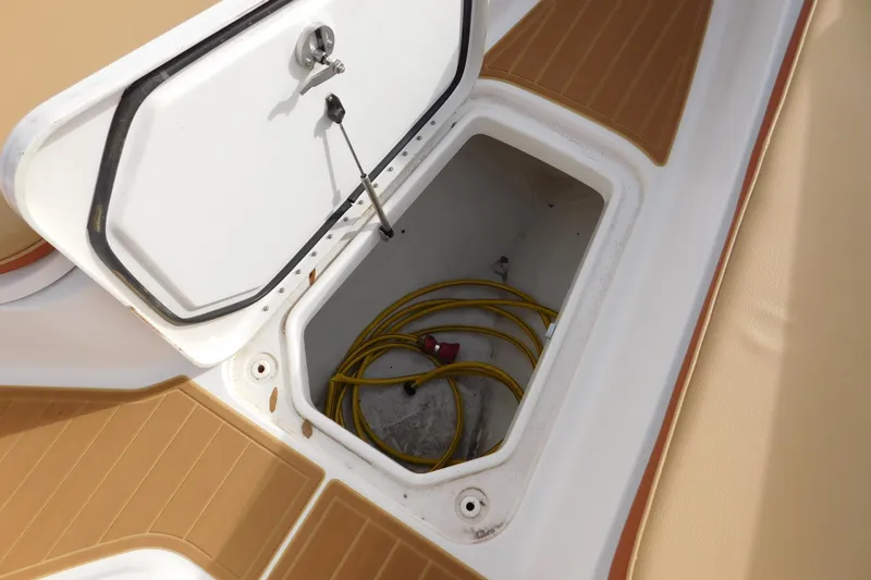 Slide: The Image of Open storage compartment on 2008 Wellcraft 27 Scarab Tournament boat with coiled yellow cable. - 41