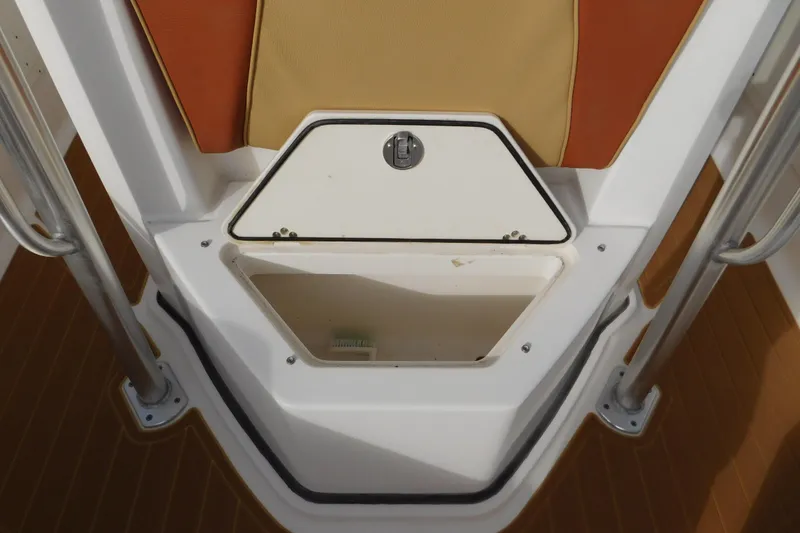 Slide: The Image of 2008 Wellcraft 27 Scarab Tournament boat storage compartment with tan and orange seating. - 48