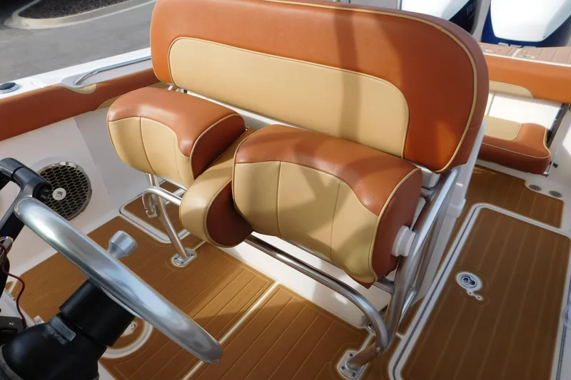 Slide: The Image of 2008 Wellcraft 27 Scarab Tournament boat interior with tan and brown seating. - 54