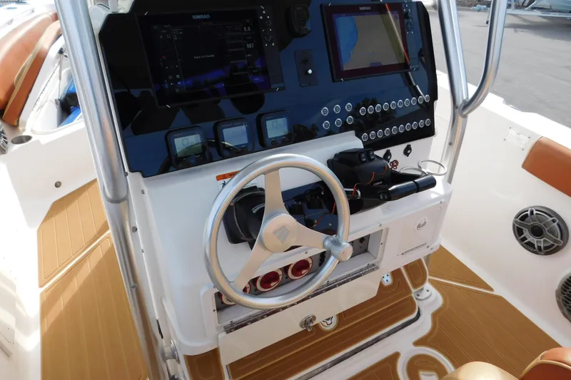Slide: The Image of Console of 2008 Wellcraft 27 Scarab Tournament boat with steering wheel and navigation equipment. - 55