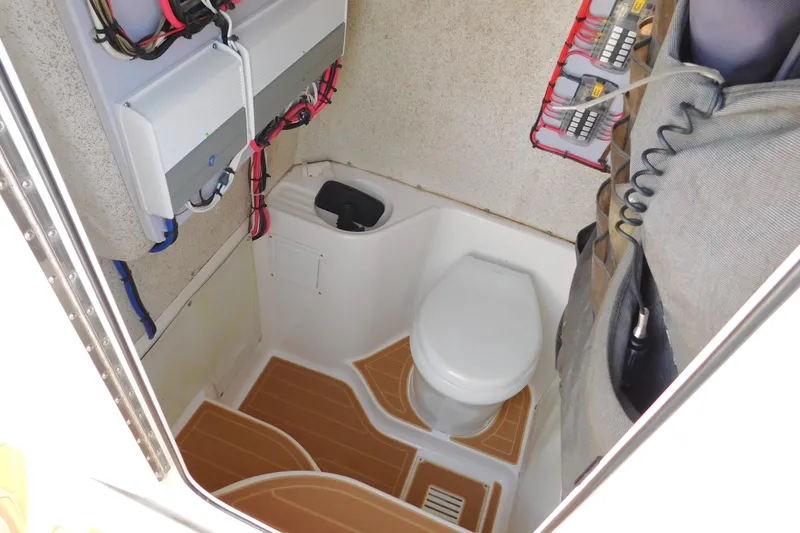 Slide: The Image of 2008 Wellcraft 27 Scarab Tournament boat interior with toilet and electrical panels. - 56