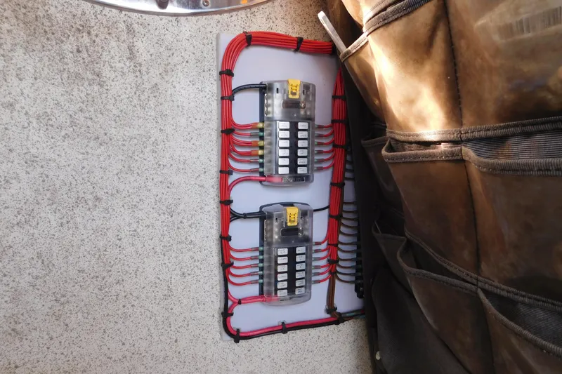 Slide: The Image of Electrical panel with red wiring on a 2008 Wellcraft 27 Scarab Tournament boat. - 58